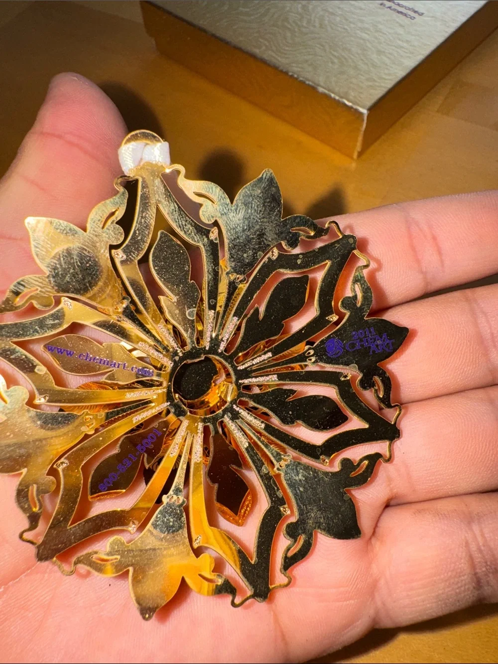2 gold-finished decorative metal snowflake or floral ornaments made by ChemArt